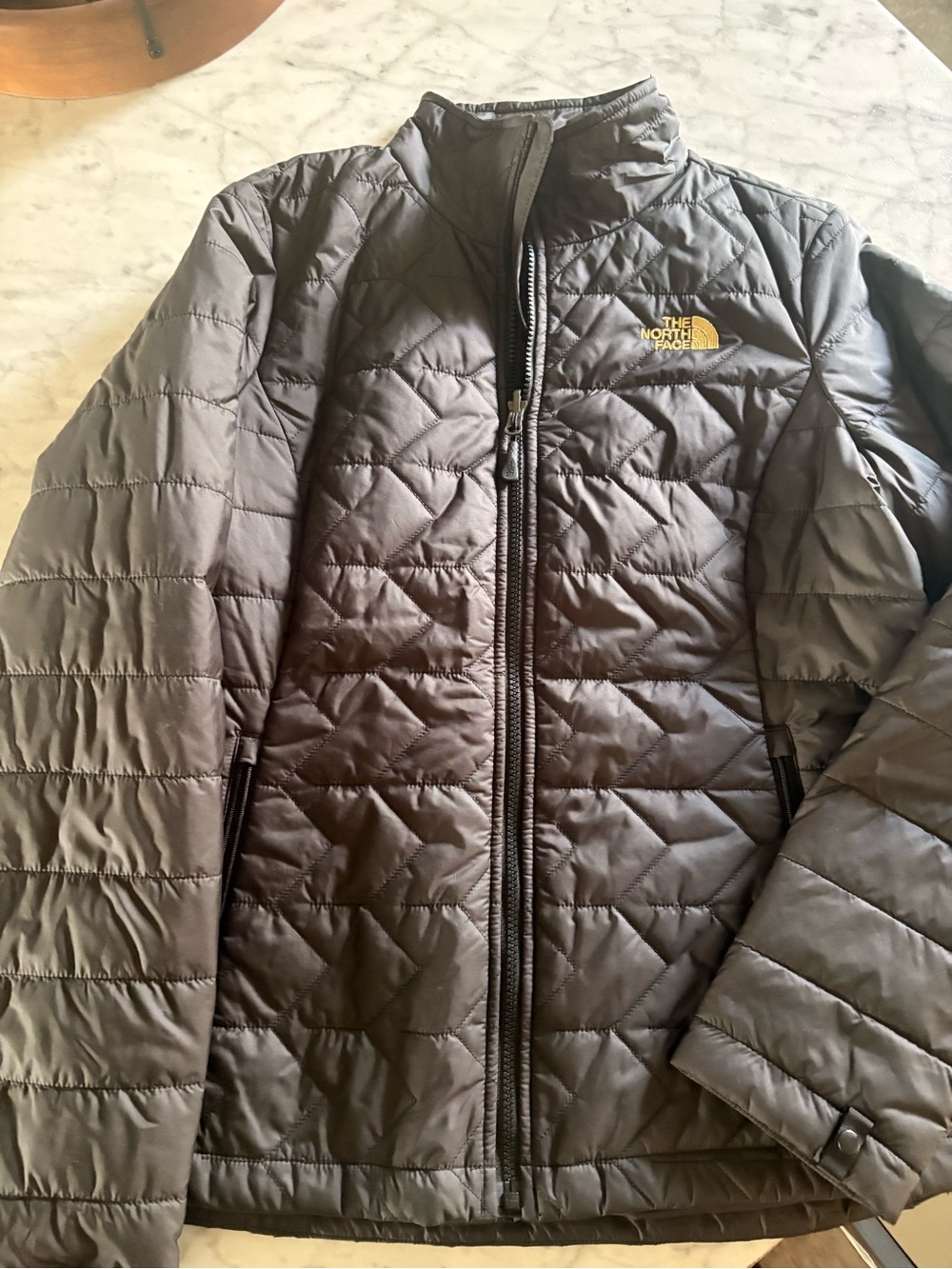 The North Face black Quilted Jacket with gold Logo